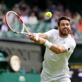 Cameron Norrie stretches for a return on Centre Court
