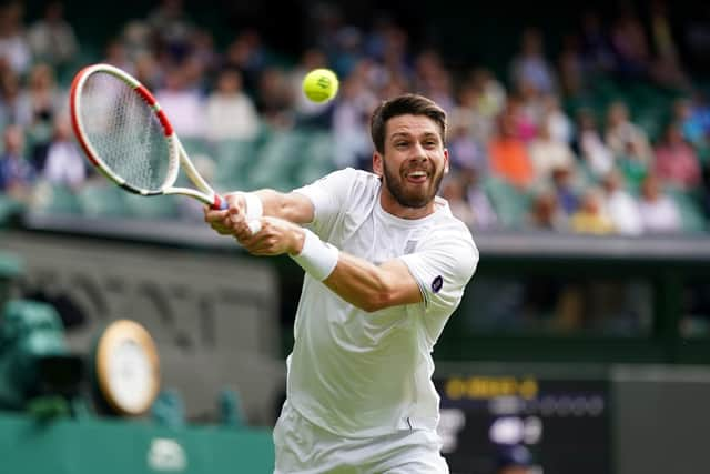 Cameron Norrie stretches for a return on Centre Court