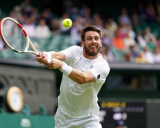 Cameron Norrie stretches for a return on Centre Court