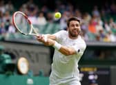 Cameron Norrie stretches for a return on Centre Court