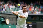 Cameron Norrie stretches for a return on Centre Court