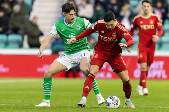 Aberdeen's Jamie McGrath tussles with Hibs' Joe Newell during the match at Easter Road.