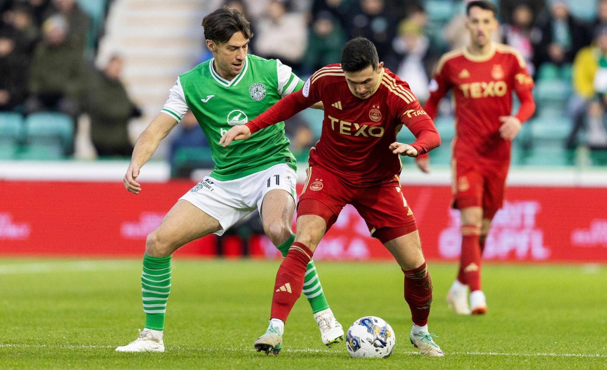 Aberdeen's Jamie McGrath tussles with Hibs' Joe Newell during the match at Easter Road.