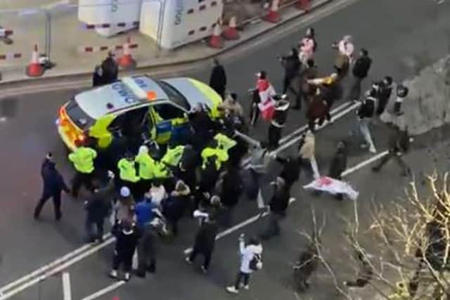 Video grab image courtesy of Conor Noon of clashes between police and protesters in Westminster as officers use a police vehicle to escort Labour leader Sir Keir Starmer to safety. (Picture credit: Conor Noon)