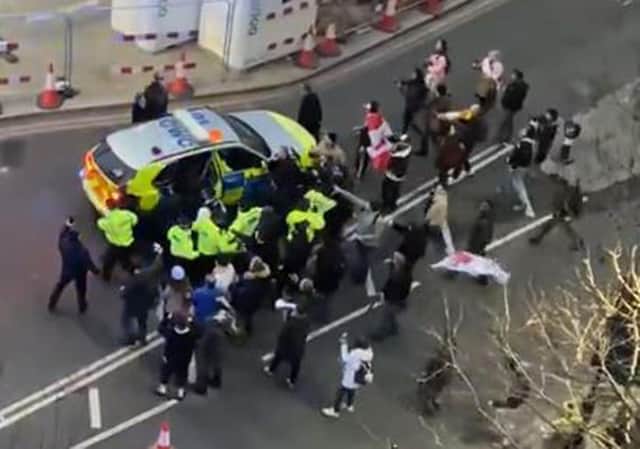 Video grab image courtesy of Conor Noon of clashes between police and protesters in Westminster as officers use a police vehicle to escort Labour leader Sir Keir Starmer to safety. (Picture credit: Conor Noon)