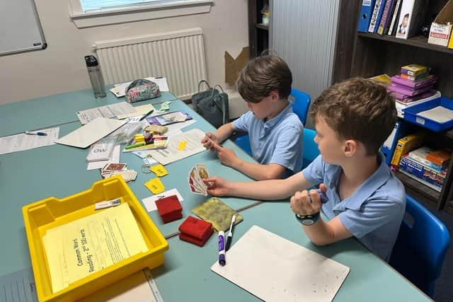 A learner in Edinburgh has brought a friend along to play a game which reinforces phonic learning