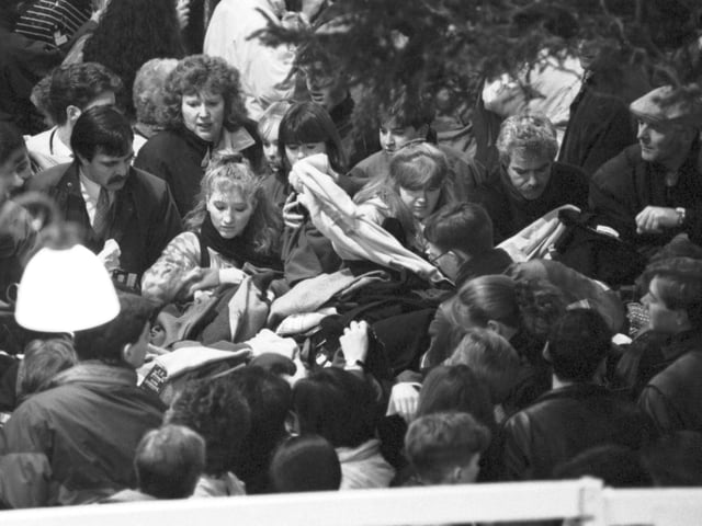 Shoppers can be seen here fighting to find the best deals at the Boxing Day Sales in the store. Year: 1992