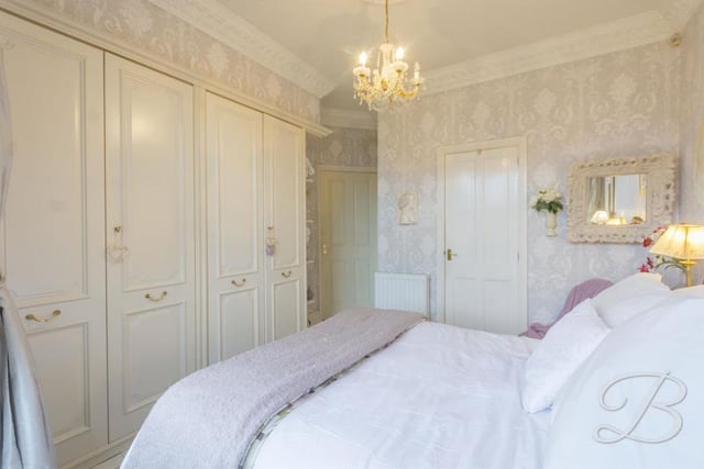 The master bedroom also features these magnificent fitted wardrobes, and en suite facilities.