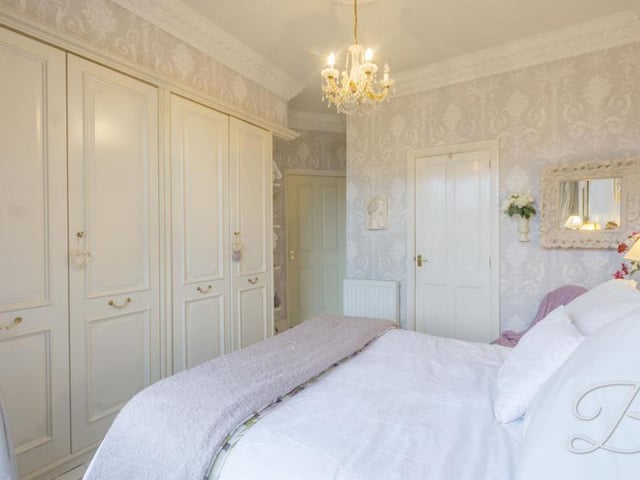The master bedroom also features these magnificent fitted wardrobes, and en suite facilities.