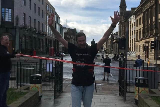 Gary Wicksted finished his walking challenge in George Street, Edinburgh on Saturday.