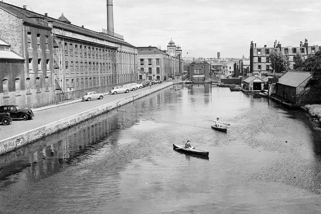 Boys in canoes on the Union Canal at Viewforth in July 1957 with the North British Rubber Company's Castle Mills on the left.
