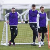 Hearts manager Robbie Neilson takes in training alongside players Michael Smith, Lewis Neilson and Stephen Kingsley.