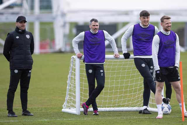 Hearts manager Robbie Neilson takes in training alongside players Michael Smith, Lewis Neilson and Stephen Kingsley.