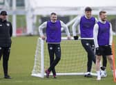 Hearts manager Robbie Neilson takes in training alongside players Michael Smith, Lewis Neilson and Stephen Kingsley.