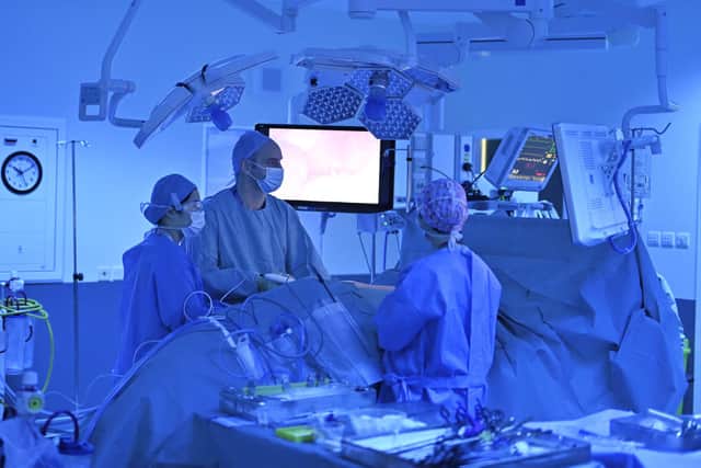 Mr Sutherland and his team during surgery to remove Cat Thomson's kidney. Picture: John Devlin/JPIMedia