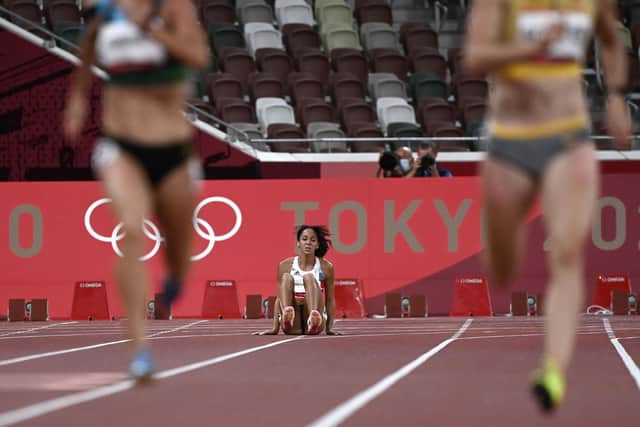 Katarina Johnson-Thompson (C) is injured during the women's heptathlon 200m