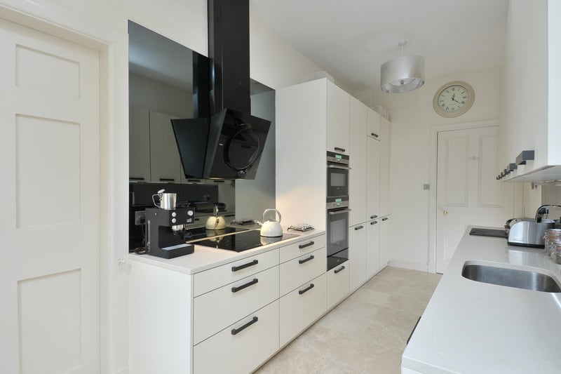 The contemporary kitchen by Kitchens International features high-quality units and appliances