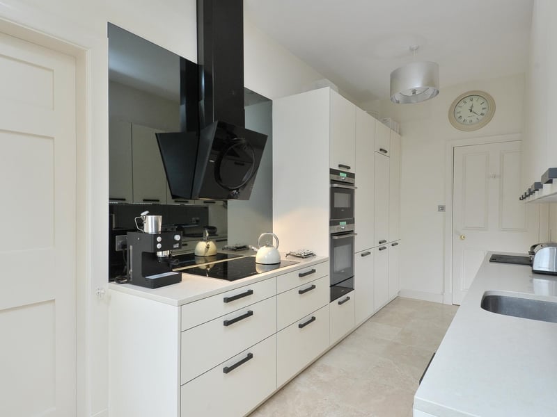The contemporary kitchen by Kitchens International features high-quality units and appliances
