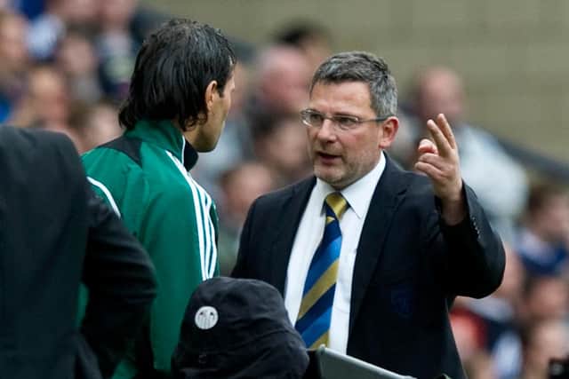 Levein speaks to the fourth official during Scotland's clash with Czech Republic in 2011.