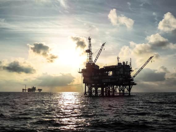An offshore oil platform at sunset