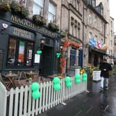 Even the pubs that are open, like this one in Edinburgh, decked out for St Patrick's Day, were unusually quiet (Picture: Andrew Milligan/PA Wire)