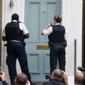 Police were filmed by reporters who were outside Cummings’ house in London