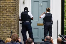 Police were filmed by reporters who were outside Cummings’ house in London