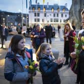 People take part in a memorial protest outside the Scottish Parliament in Edinburgh to mark the anniversary of the murder of Sarah Everard and other women killed by men (Photo: Jane Barlow/PA Wire).