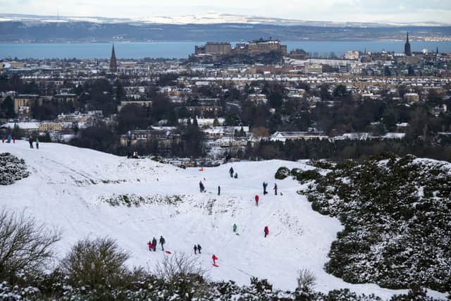 A view of Edinburgh Castle from The Braids with people sledging in the snow. Picture: Andrew O'Brien