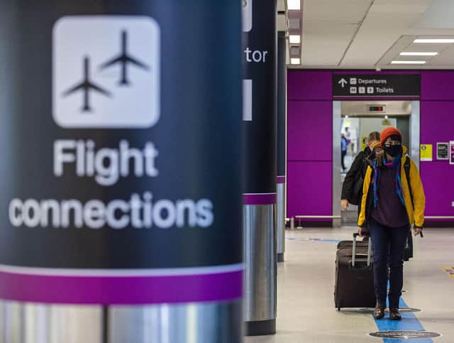 Travellers arrive at Edinburgh Airport wearing face masks. Picture: Lisa Ferguson