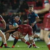 Hamish Watson of Edinburgh is tackled by Dan Davis of Scarlets. Photo by Gruffydd Thomas/Huw Evans/Shutterstock (13773604af)