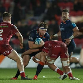 Hamish Watson of Edinburgh is tackled by Dan Davis of Scarlets. Photo by Gruffydd Thomas/Huw Evans/Shutterstock (13773604af)