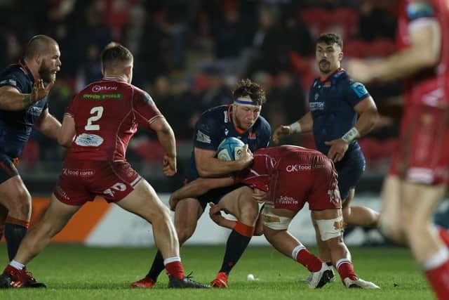 Hamish Watson of Edinburgh is tackled by Dan Davis of Scarlets. Photo by Gruffydd Thomas/Huw Evans/Shutterstock (13773604af)