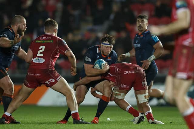 Hamish Watson of Edinburgh is tackled by Dan Davis of Scarlets. Photo by Gruffydd Thomas/Huw Evans/Shutterstock (13773604af)