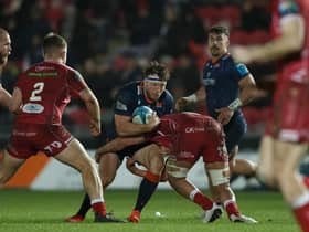 Hamish Watson of Edinburgh is tackled by Dan Davis of Scarlets. Photo by Gruffydd Thomas/Huw Evans/Shutterstock (13773604af)