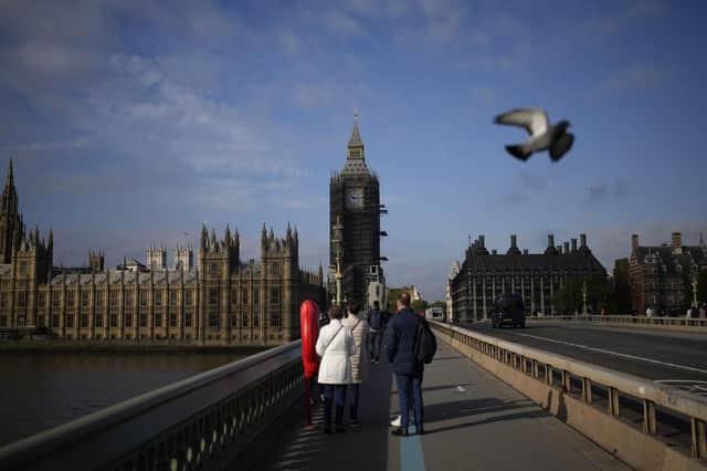 The scaffolded Big Ben, and the Houses of Parliament are seen from Westminster Bridge, in London, yesterday.