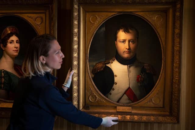English Heritage of Historic Property steward Viktoria Szalay positioning a painting of Napoleon Bonaparte at Apsley House, London, ahead of reopening to the public. Picture: Christopher Ison/English Heritage/PA Wire