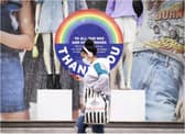A person wearing a face mask walks past a mural in Edinburgh. Picture: Lisa Ferguson