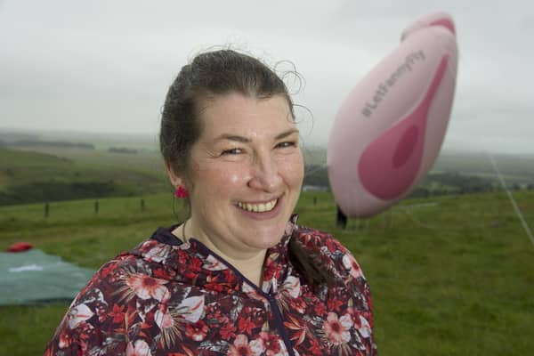 Elaine Miller, a comedian and physiotherapist pictured with a 19ft inflatable model of a vagina, is being investigated for revealing her merkin in the Scottish Parliament (Picture: Sandy Young/PA)