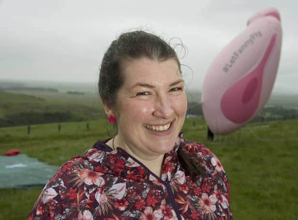 Elaine Miller, a comedian and physiotherapist pictured with a 19ft inflatable model of a vagina, is being investigated for revealing her merkin in the Scottish Parliament (Picture: Sandy Young/PA)
