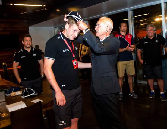 Former Scotland team doctor Donald Macleod presents Finn Russell with his first cap following his debut against the United States in Houston in 2014. Picture: Craig Watson/SNS