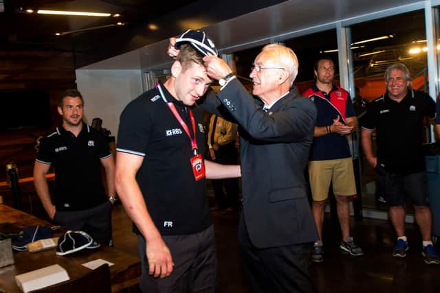 Former Scotland team doctor Donald Macleod presents Finn Russell with his first cap following his debut against the United States in Houston in 2014. Picture: Craig Watson/SNS