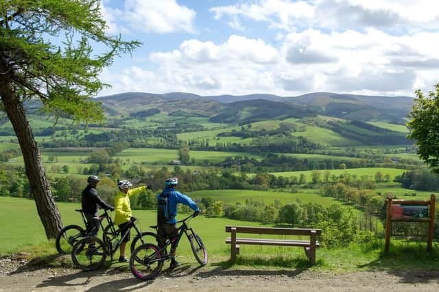 Cyclists enjoy the view over the Tweed valley from Glentress Forest, in the Borders, one of the locations which will be hosting the UCI Cycling World Championships in August. Picture: VisitScotland/Ian Rutherford