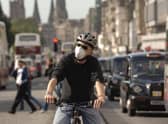 A cyclist on Princes Street wearing an anti-pollution mask. Scotland is well-placed to lead the way in creating cleaner air, writes Richard Dixon. PIC: Jon Savage.