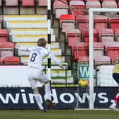 Liam Fontaine blocks a shot from Dunfermline's Ewan Henderson.