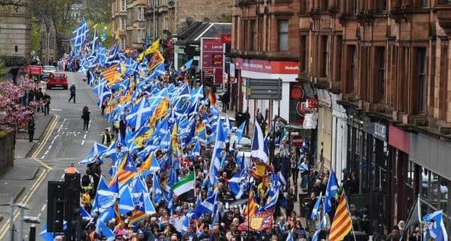 Thousands of demonstrators carry Saltire flags, the national flag of Scotland, as they march in support of Scottish independence through the streets of Glasgow. Pic: Getty