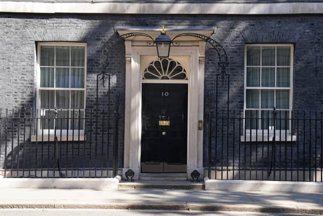 The famous black door of 10 Downing Street, London.