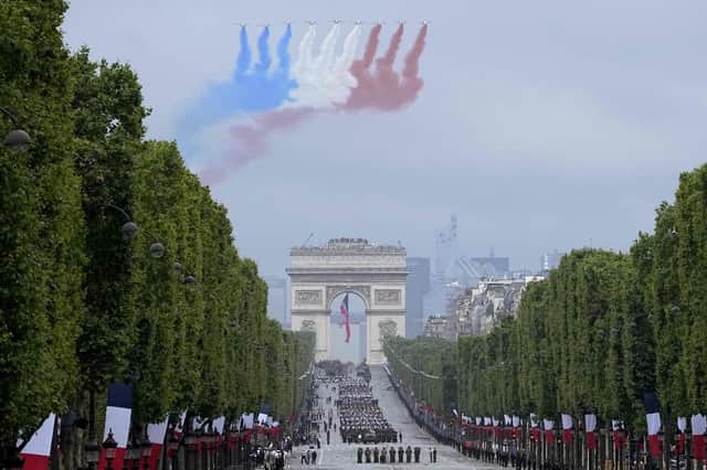 Alphajet aircraft fly over L'Arc de Triomphe during the annual Bastille Day military parade on the Champs-Elysees avenue in Paris on 14 July 2021 (Getty Images)