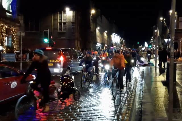 InfraSisters riders head down the Royal Mile in Edinburgh on Friday December 1. (Photo by Alastair Dalton/The Scotsman)
