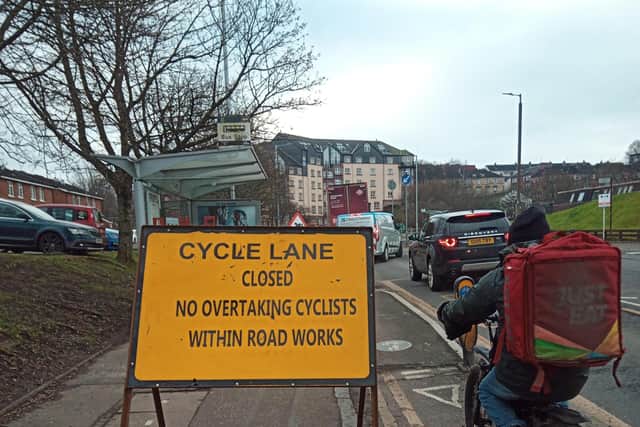 Motorists warned not to overtake cyclists through roadworks in Clarence Drive in the Broomhill area of Glasgow. Picture: The Scotsman